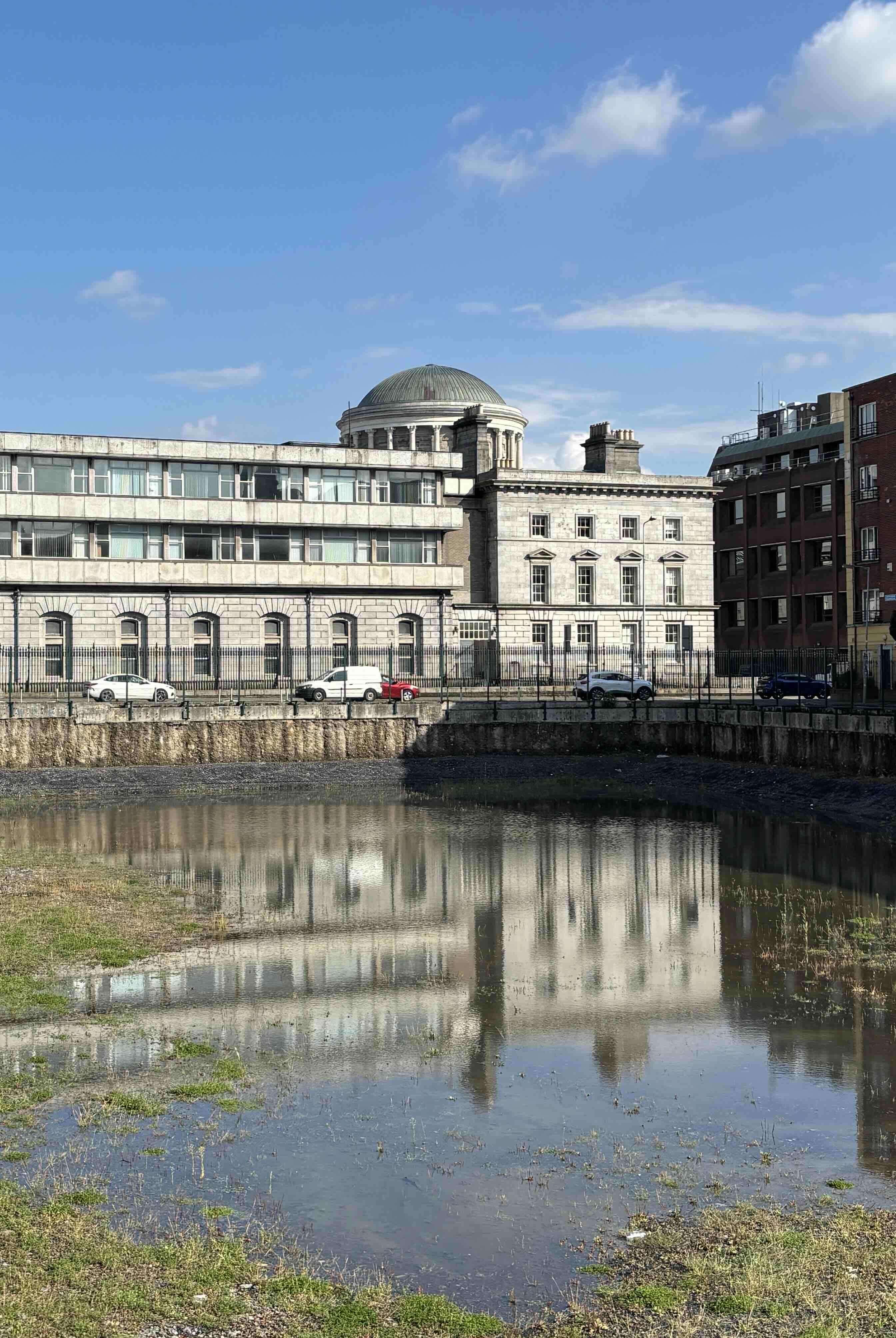 The flooded Hammond Lane site in Smithfield, with the Four Courts dome reflected in standing water
