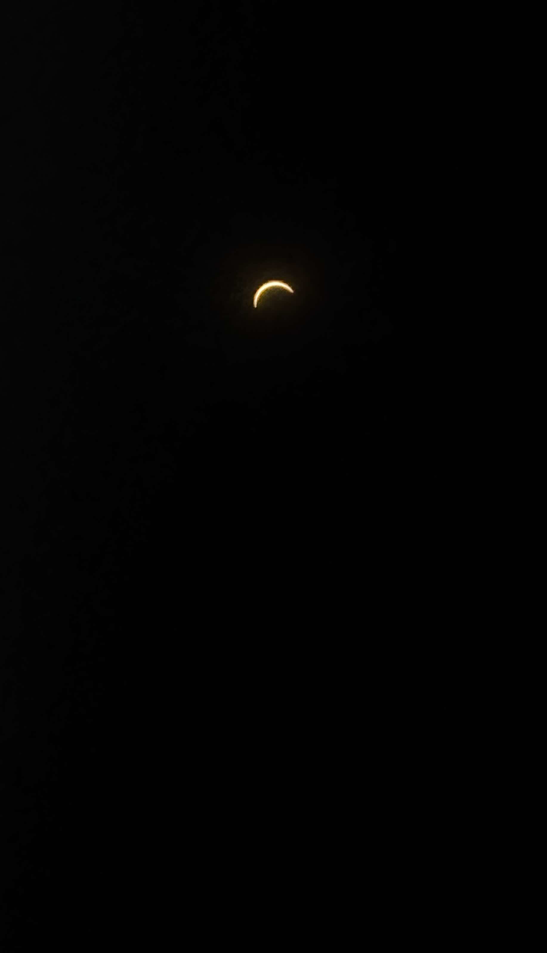 A thin golden crescent of the Sun during the partial solar eclipse of 12 August 2026, photographed from Dublin